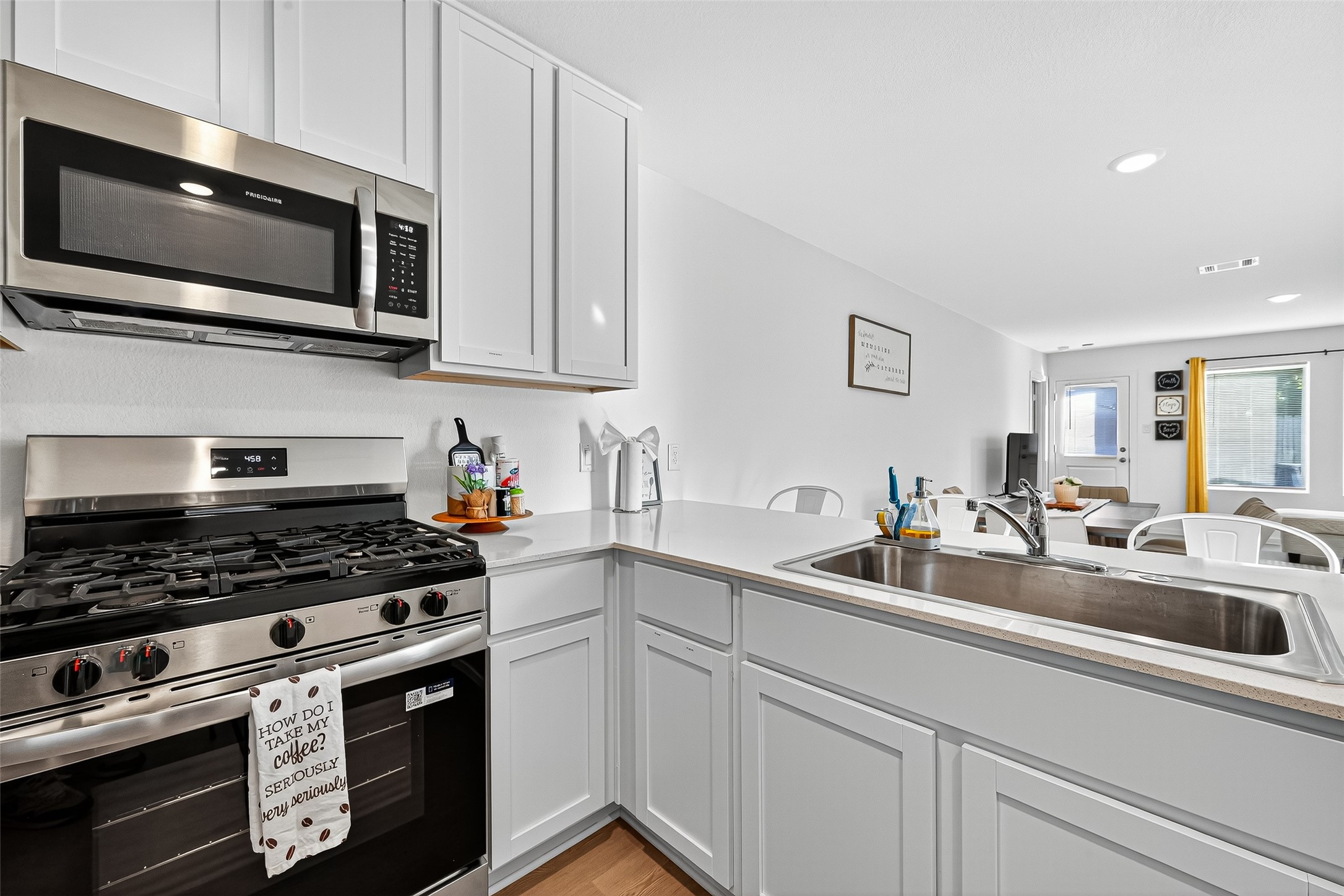 228 Laura Leigh Lane Angleton, TX 77515 - Photo 12 of 37 a kitchen with stainless steel appliances a sink a stove and microwave