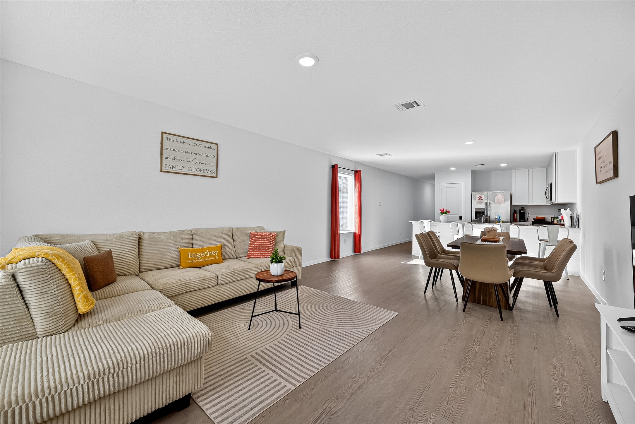 228 Laura Leigh Lane Angleton, TX 77515 - Photo 21 of 37 a living room with furniture wooden floor and a kitchen view