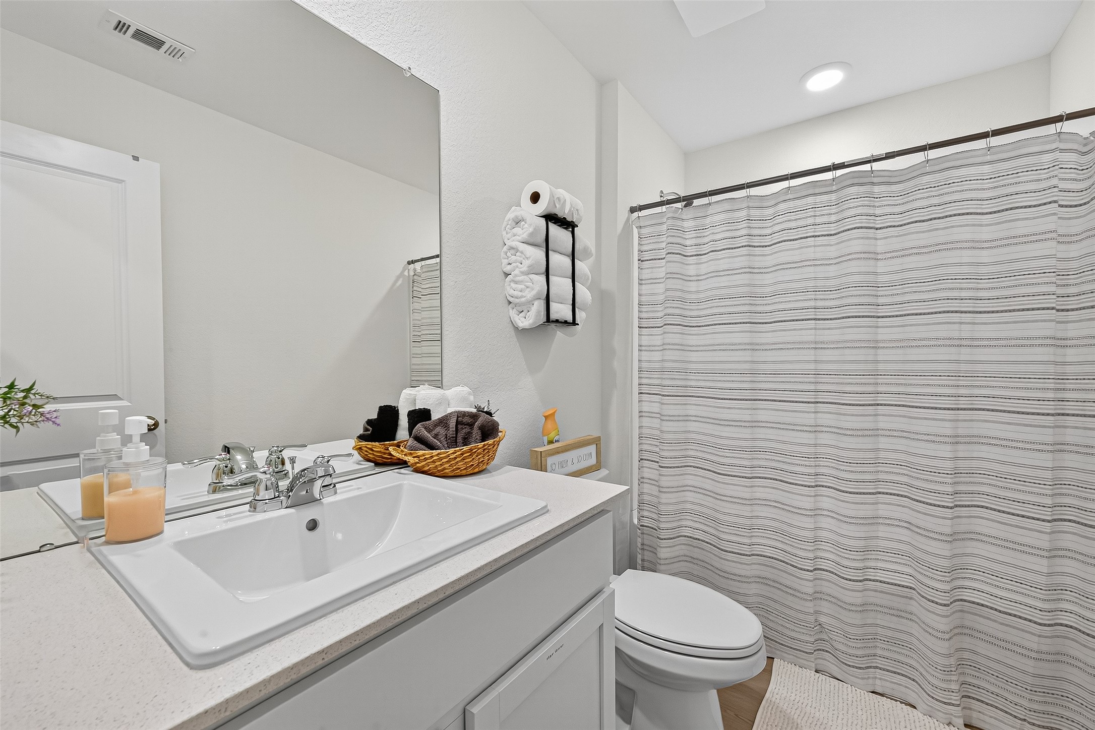228 Laura Leigh Lane Angleton, TX 77515 - Photo 23 of 37 a bathroom with a sink a toilet and shower curtain