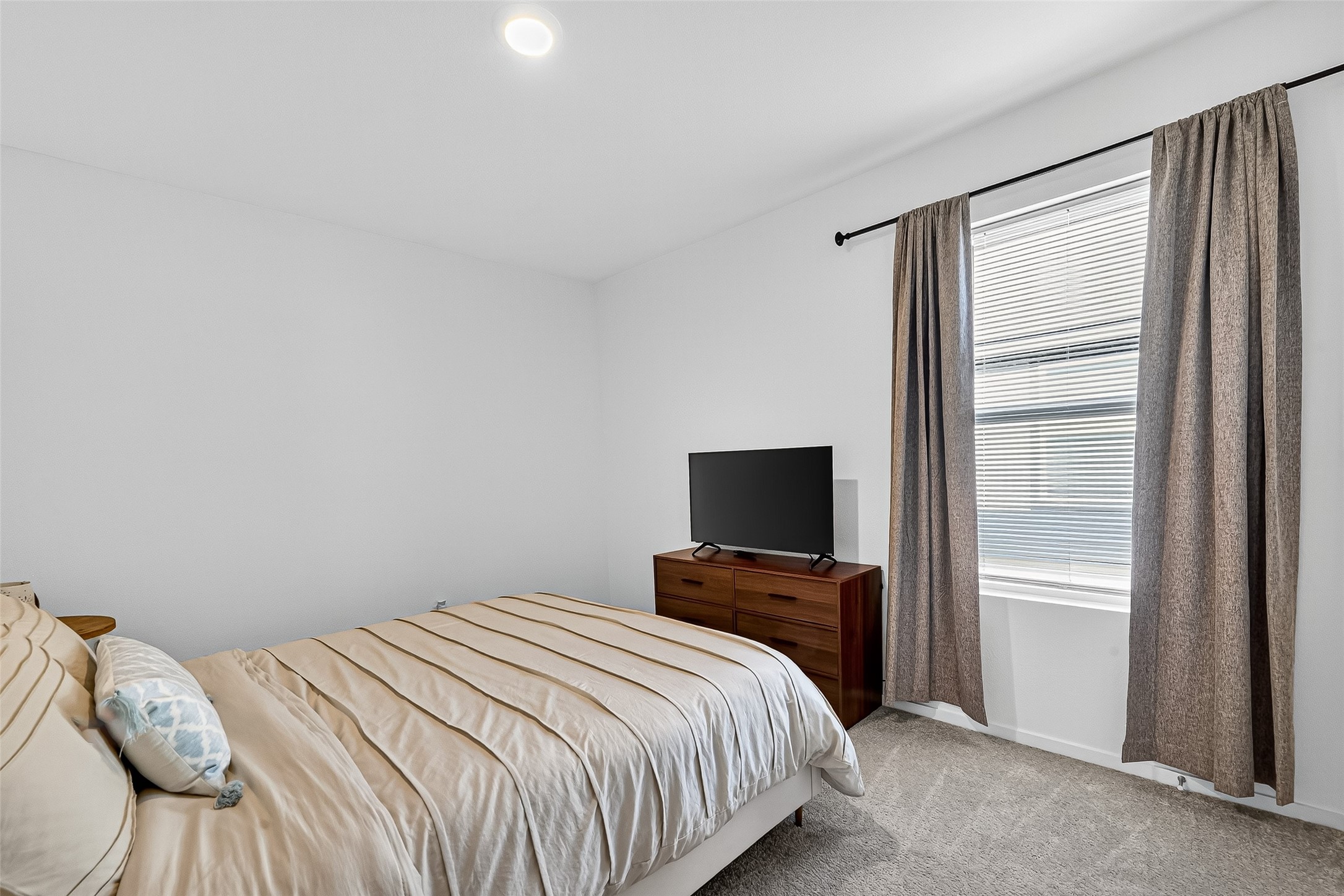 228 Laura Leigh Lane Angleton, TX 77515 - Photo 25 of 37 a bedroom with a bed and a flat screen tv