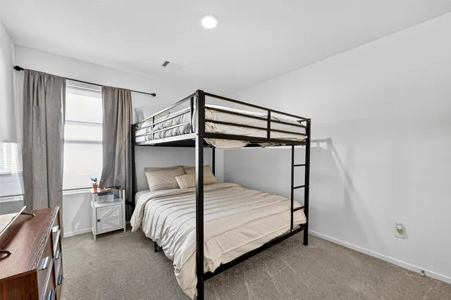 a bedroom with a bed and a night stand