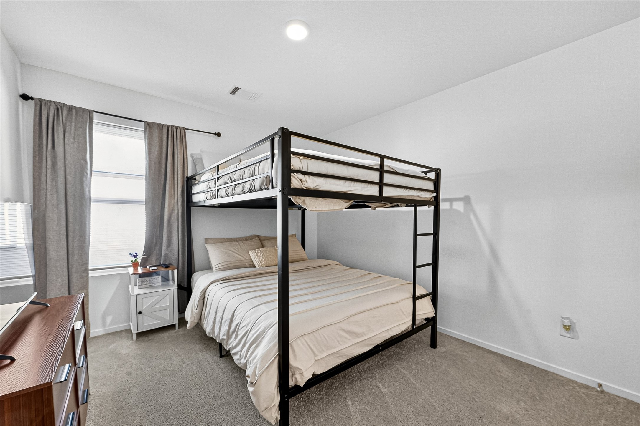 228 Laura Leigh Lane Angleton, TX 77515 - Photo 27 of 37 a bed sitting in a bedroom next to a window