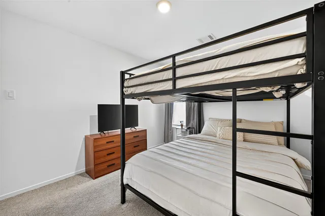 a bedroom with a bed and a television