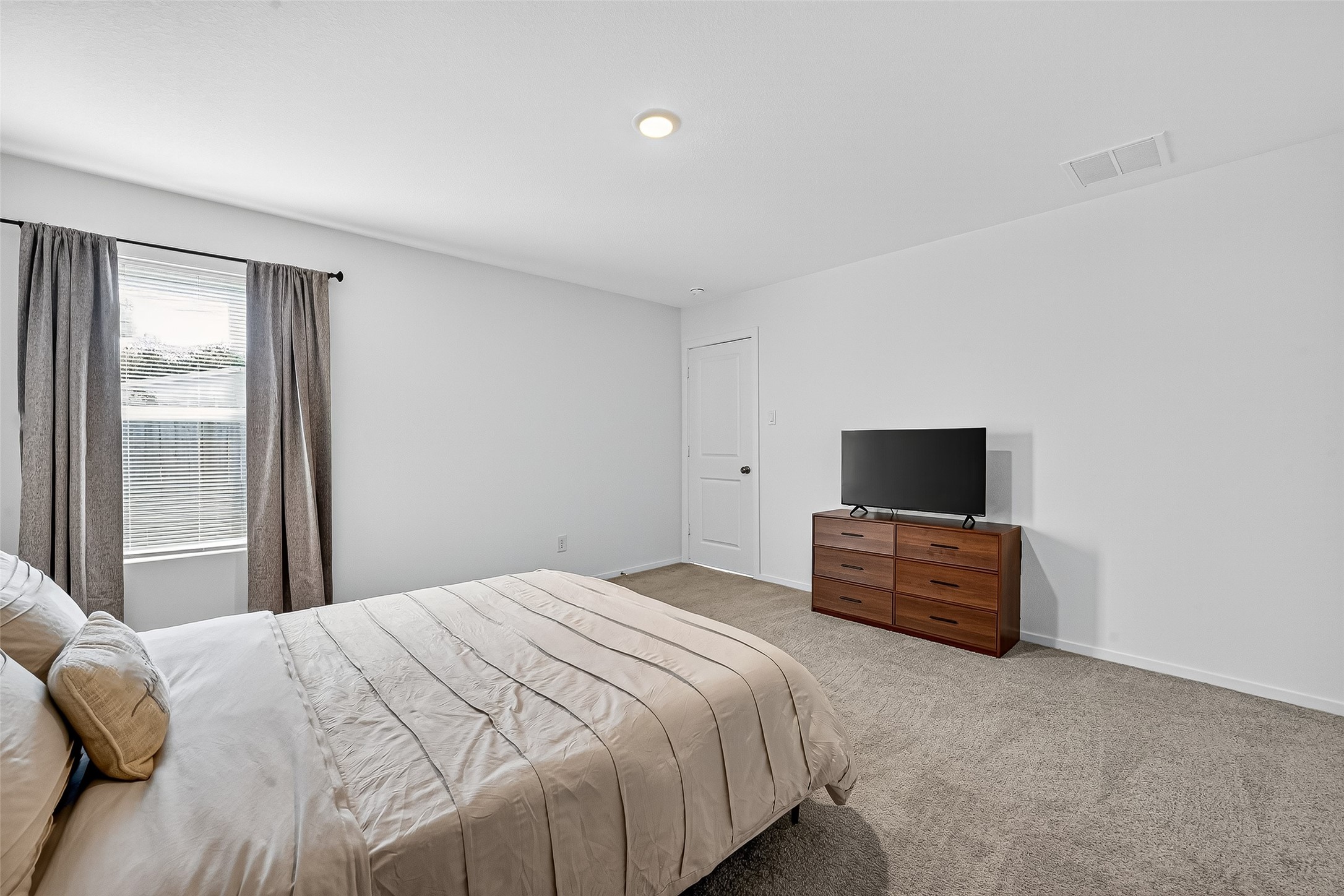 228 Laura Leigh Lane Angleton, TX 77515 - Photo 30 of 37 a bedroom with a bed and a television