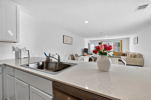 a kitchen with stainless steel appliances a sink a stove and microwave
