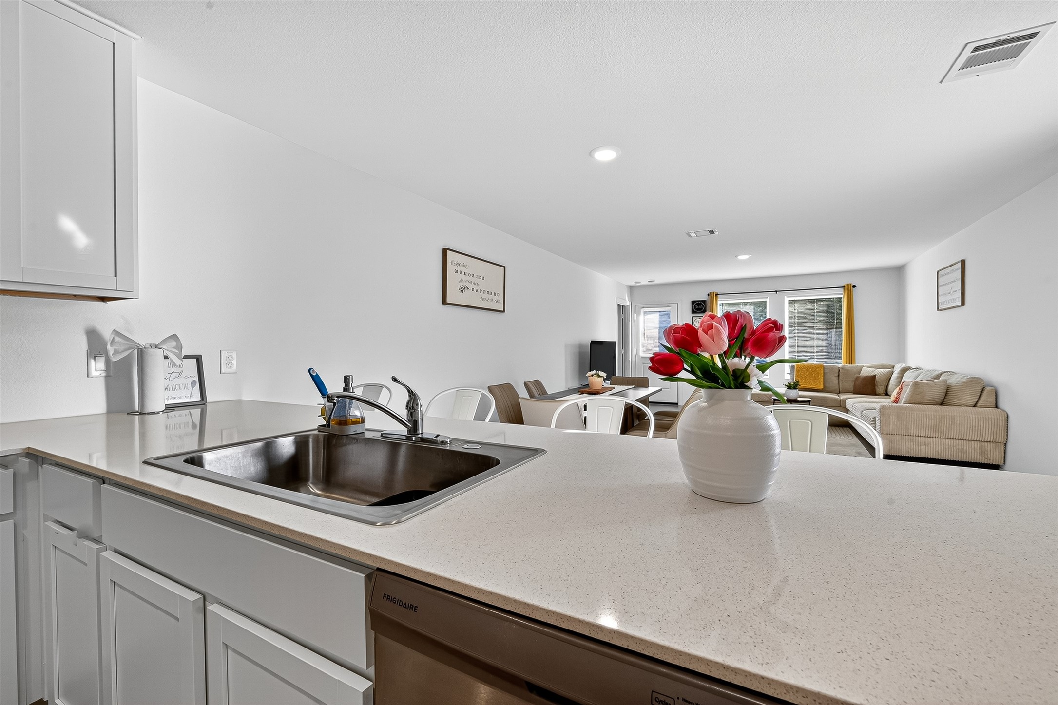 228 Laura Leigh Lane Angleton, TX 77515 - Photo 10 of 37 a kitchen with a microwave and flowers