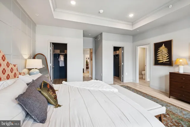 a bedroom with a large bed and a dresser