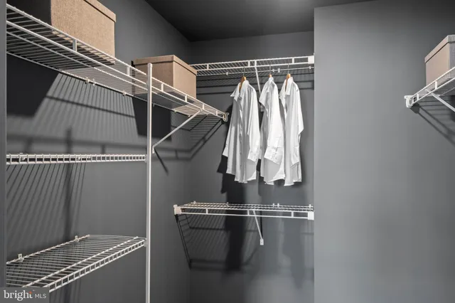 a view of walk in closet with clothes
