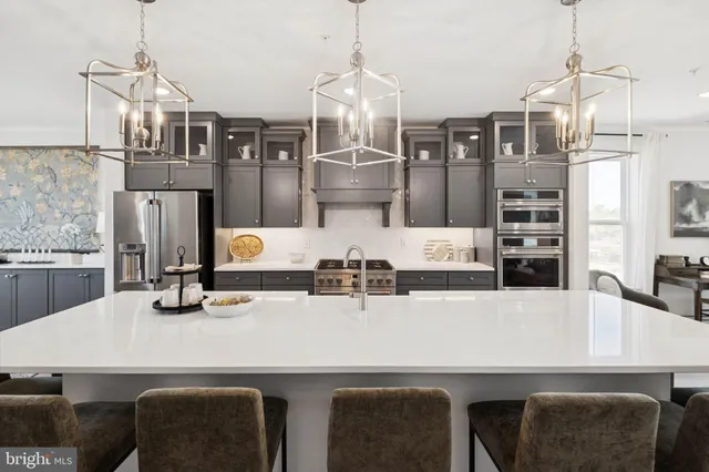a kitchen with a table chairs and refrigerator