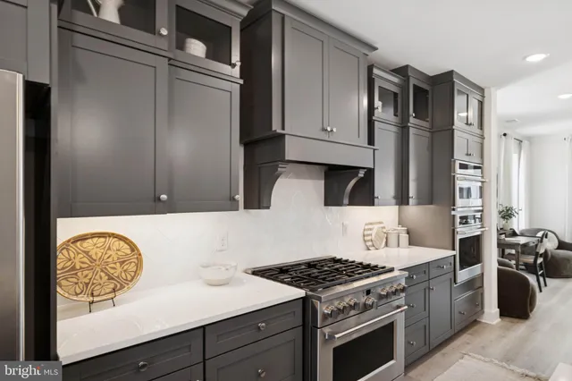 a kitchen with stainless steel appliances granite countertop a stove and a refrigerator