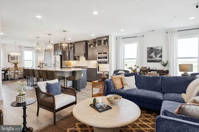 a living room with furniture kitchen and a table