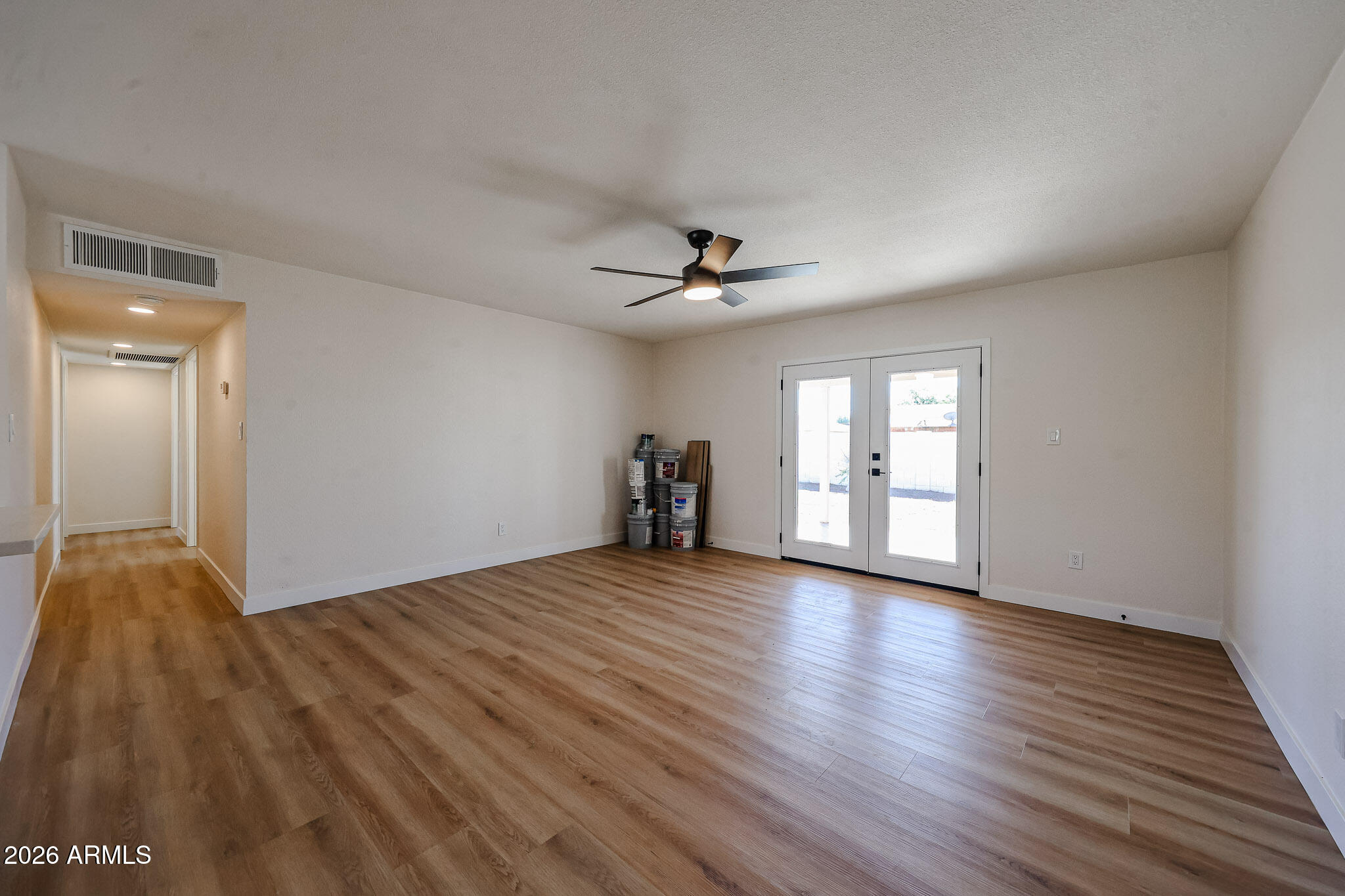 3337 West Ocotillo Road Phoenix, AZ 85017 - Photo 7 of 30 a view of empty room with wooden floor and fan