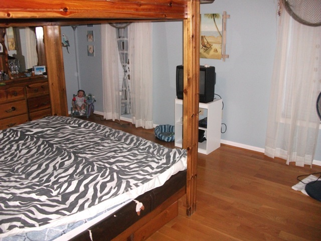 4012 Hatchett Road Penhook, VA 24137 - Photo 8 of 29 a bedroom with a bed and wooden floor