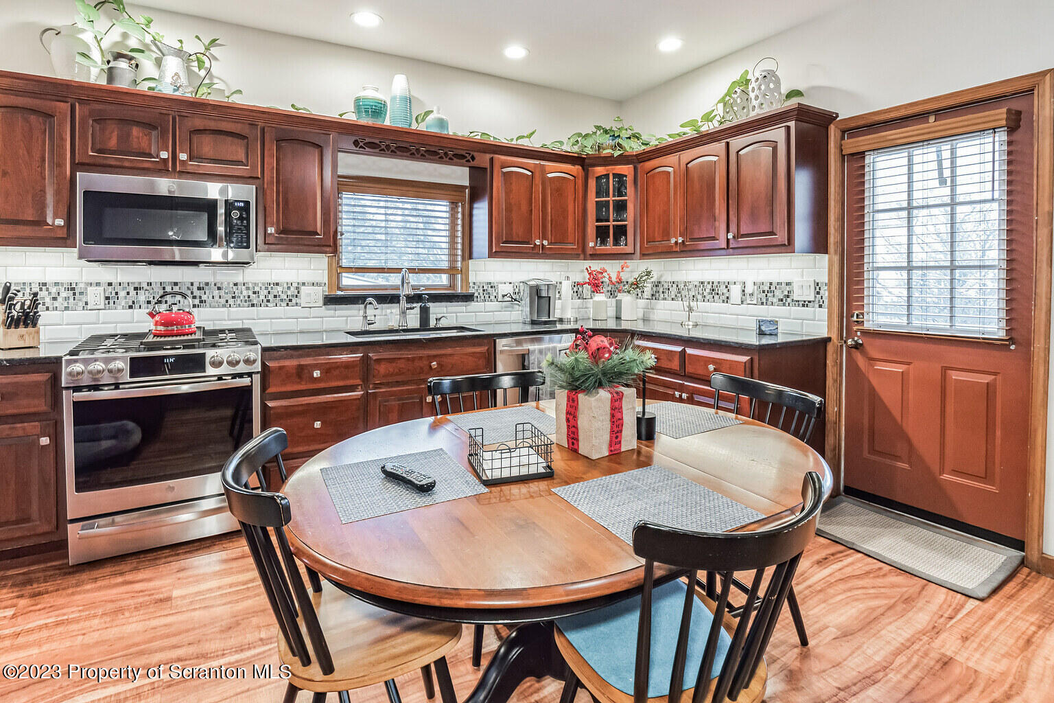 715 Landis Street Scranton, PA 18504 - Photo 3 of 15 a kitchen with a table chairs sink and cabinets