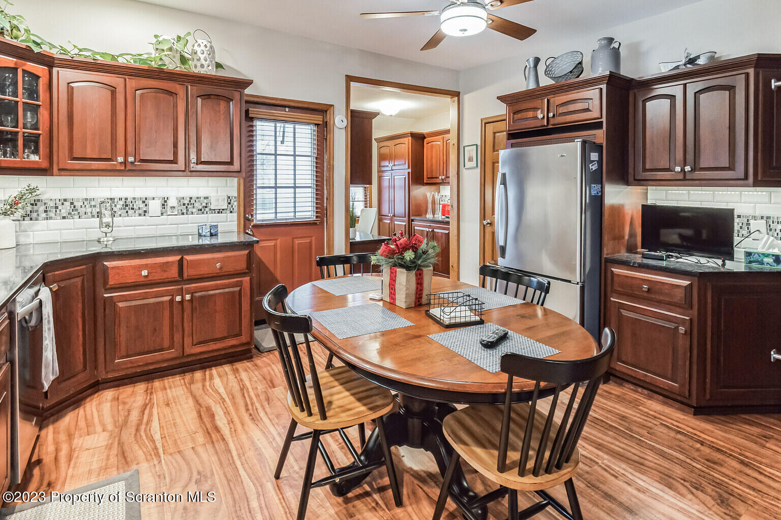 715 Landis Street Scranton, PA 18504 - Photo 4 of 15 a kitchen with stainless steel appliances granite countertop a stove a refrigerator a kitchen island a dining table and chairs with wooden floor