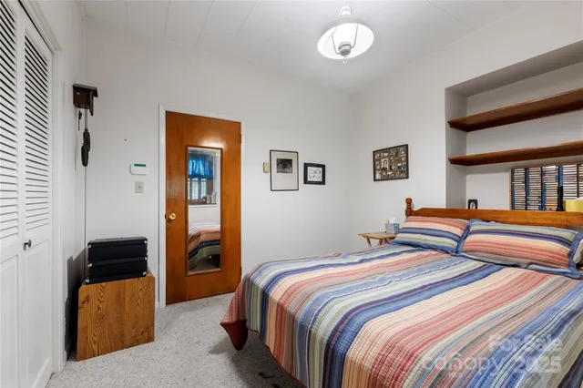 a bedroom with double bed and a window