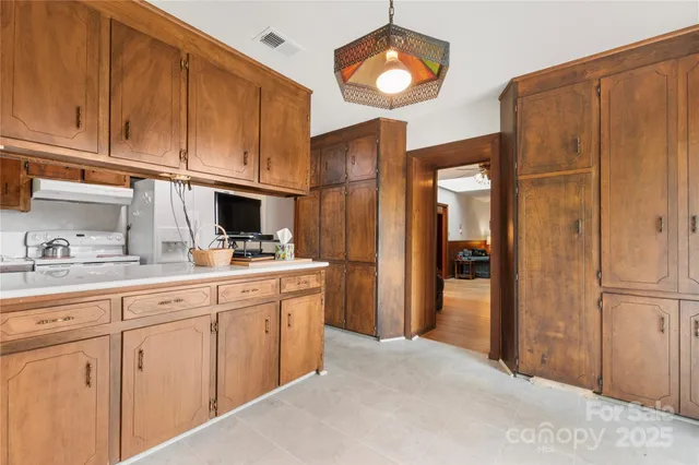 a kitchen with stainless steel appliances granite countertop a refrigerator and cabinets