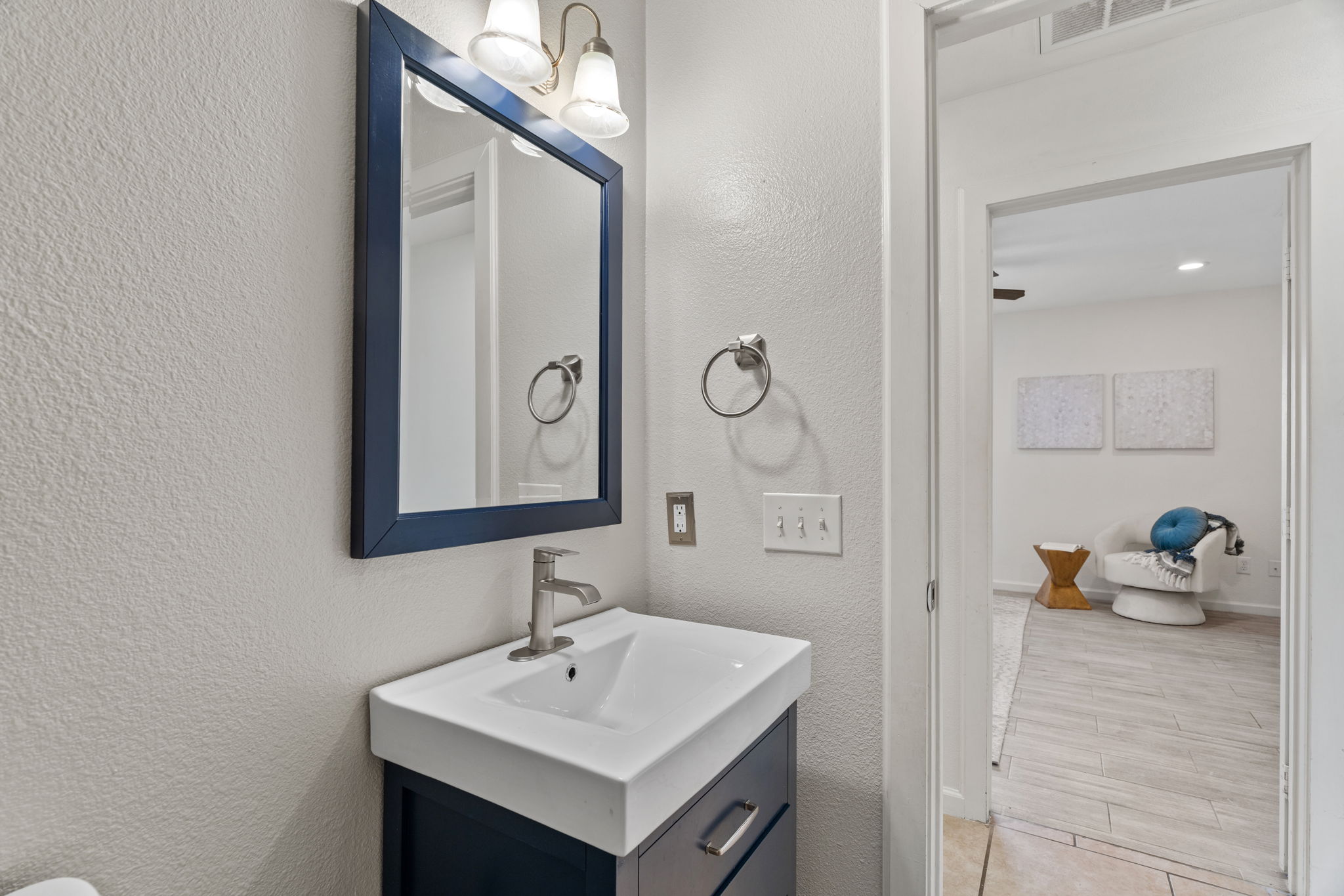 2604 Cockburn Drive Austin, TX 78745 - Photo 17 of 33 Updated vanity and lighting bring a contemporary touch to this bright secondary bathroom.