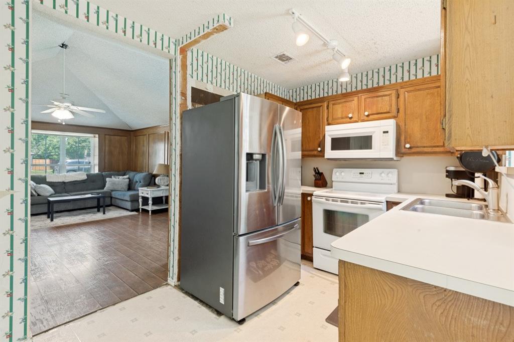 7410 Jessica Way Rowlett, TX 75088 - Photo 11 of 25 a kitchen with a refrigerator a stove and a sink