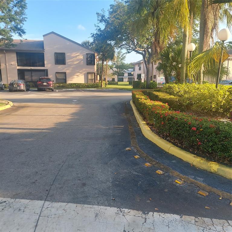 3420 Northwest 47th Avenue, Unit 3143 Pompano Beach, FL 33063 - Photo 1 of 14 a view of a street with houses