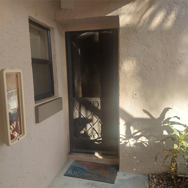 3420 Northwest 47th Avenue, Unit 3143 Pompano Beach, FL 33063 - Photo 11 of 14 a view of a entryway door