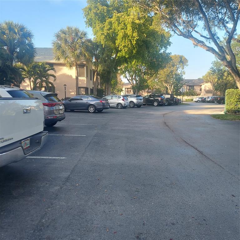 3420 Northwest 47th Avenue, Unit 3143 Pompano Beach, FL 33063 - Photo 5 of 14 a view of a street with houses