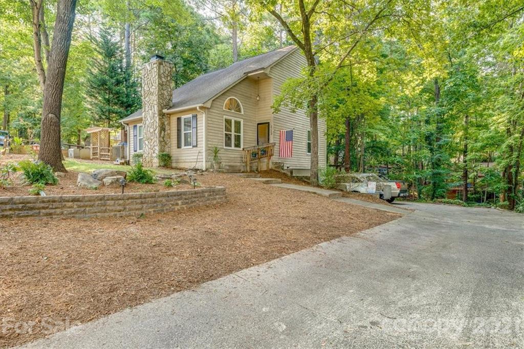 2129 Manawa Lane Tega Cay, SC 29708 - Photo 1 of 42 a view of a house with backyard and trees