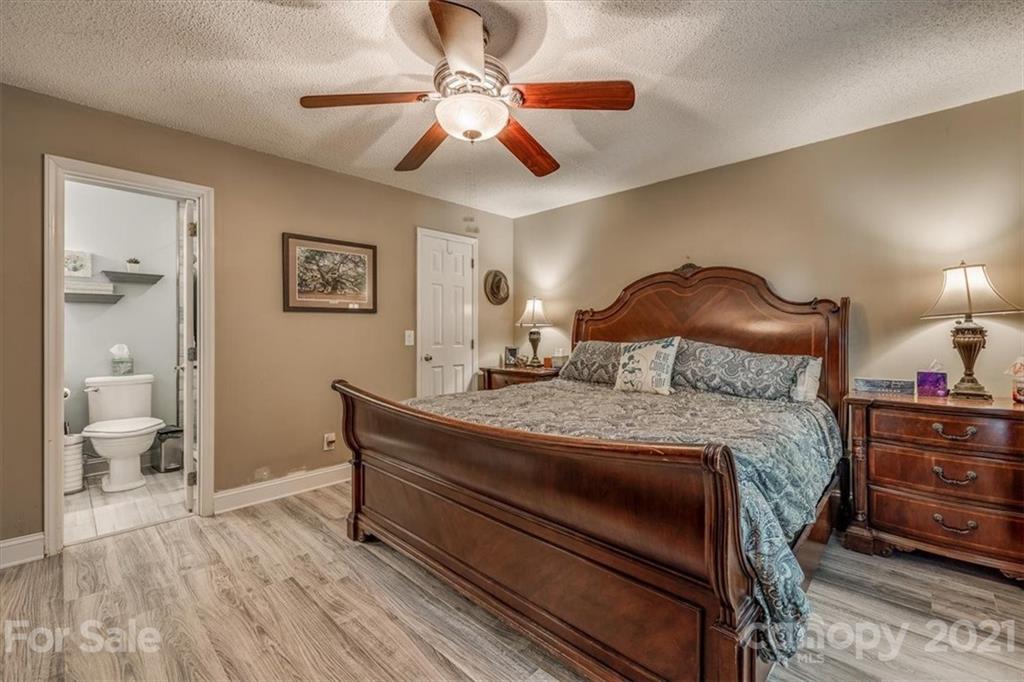 2129 Manawa Lane Tega Cay, SC 29708 - Photo 11 of 42 a bedroom with a bed and a chandelier