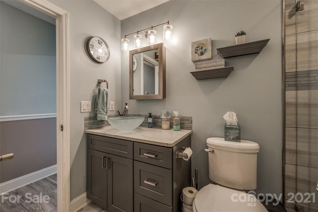 2129 Manawa Lane Tega Cay, SC 29708 - Photo 12 of 42 a bathroom with a toilet a sink and mirror