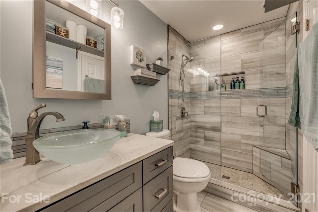 2129 Manawa Lane Tega Cay, SC 29708 - Photo 13 of 42 a bathroom with a granite countertop sink toilet and shower