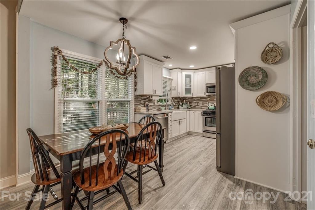 2129 Manawa Lane Tega Cay, SC 29708 - Photo 14 of 42 a view of a dining room with furniture window and wooden floor