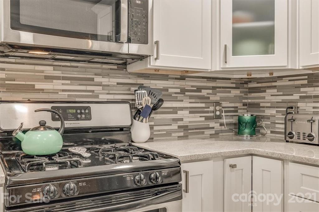 2129 Manawa Lane Tega Cay, SC 29708 - Photo 17 of 42 a kitchen with a stove and a white cabinets