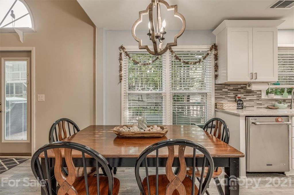 2129 Manawa Lane Tega Cay, SC 29708 - Photo 18 of 42 a view of a dining room with furniture window and wooden floor