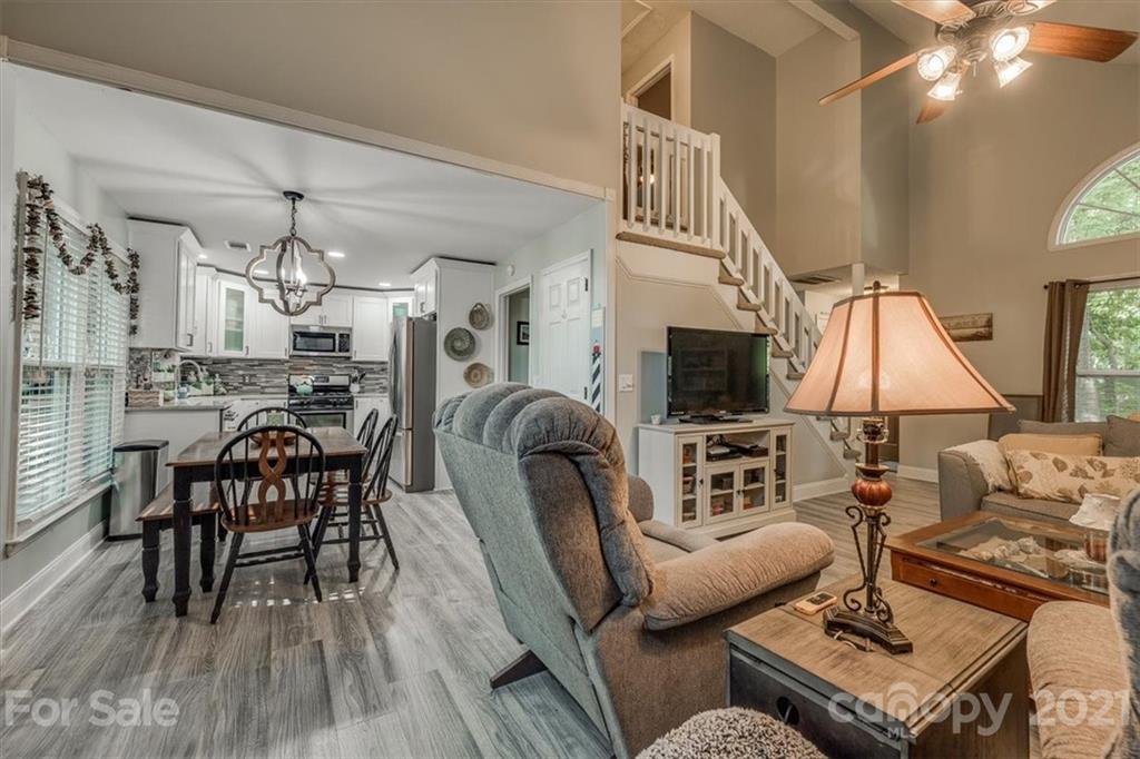 2129 Manawa Lane Tega Cay, SC 29708 - Photo 23 of 42 a living room with furniture a flat screen tv and a fireplace