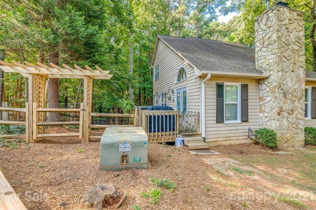 2129 Manawa Lane Tega Cay, SC 29708 - Photo 26 of 42 a backyard of a house with table and chairs