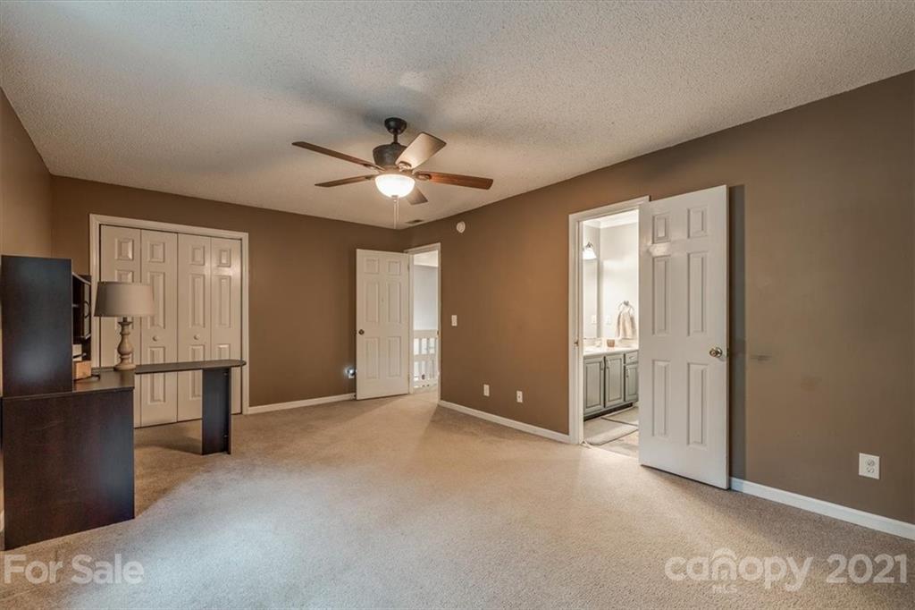2129 Manawa Lane Tega Cay, SC 29708 - Photo 6 of 42 a view of a livingroom with a chandelier fan and windows