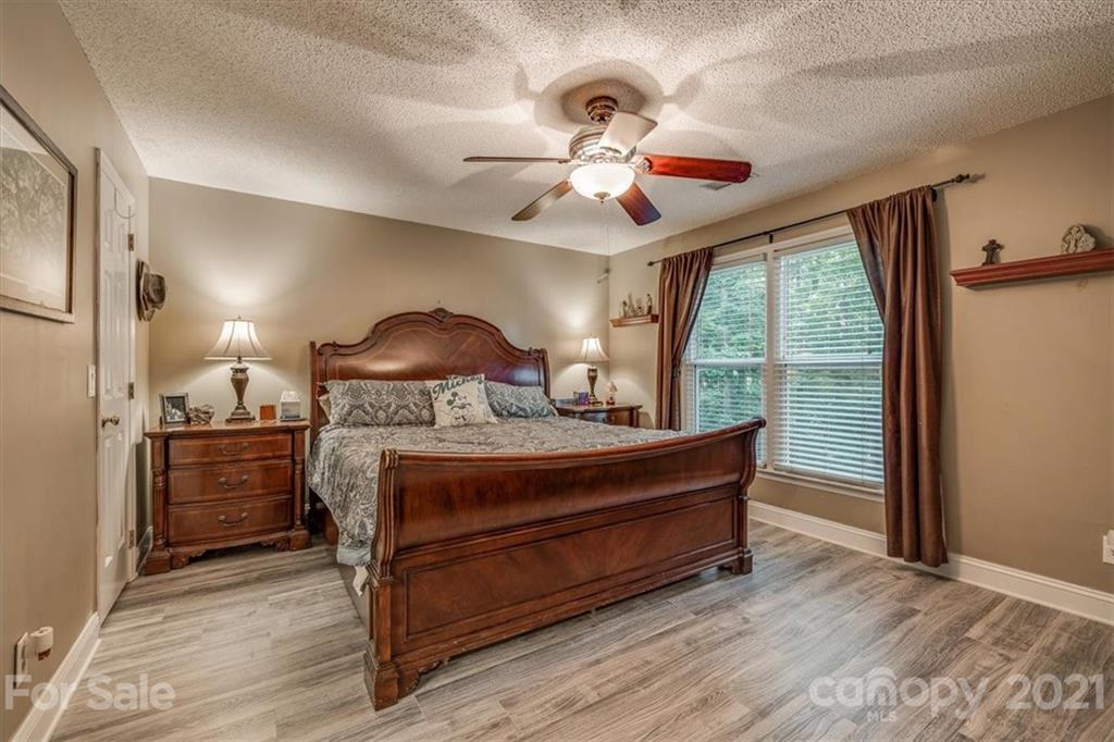 2129 Manawa Lane Tega Cay, SC 29708 - Photo 10 of 42 a bedroom with a bed and a chandelier