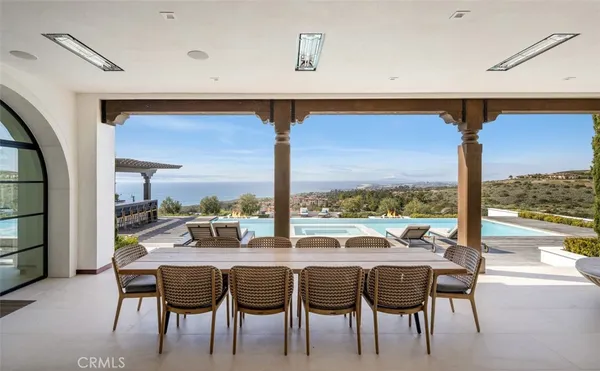 a dining room with furniture and a floor to ceiling window