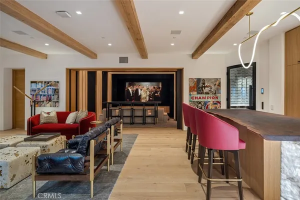 a living room with furniture a rug and a flat screen tv