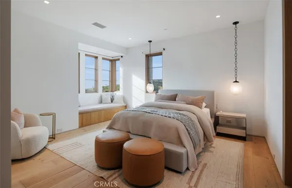 a spacious bedroom with a bed and a couch