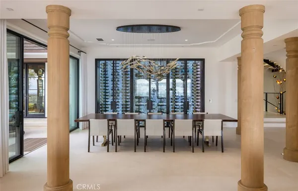a dining room with furniture and a floor to ceiling window