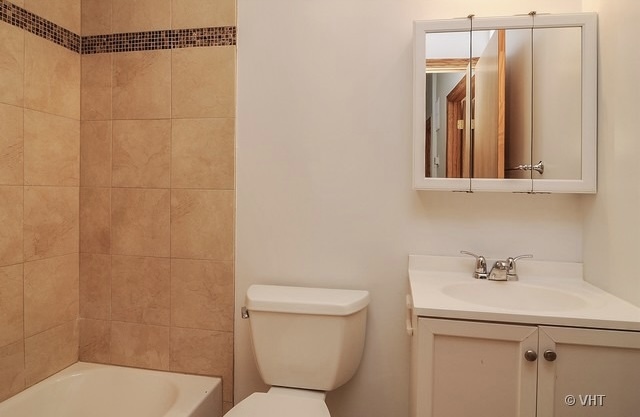 4205 North Bernard Street, Unit R Chicago, IL 60618 - Photo 9 of 12 a bathroom with a sink a toilet and shower