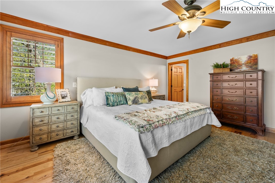 162 Pinecrest Court Boone, NC 28607 - Photo 14 of 50 a bedroom with a large bed and a chandelier