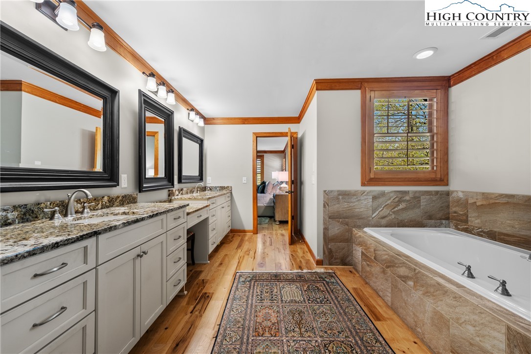 162 Pinecrest Court Boone, NC 28607 - Photo 20 of 50 a spacious bathroom with a granite countertop tub sink and mirror