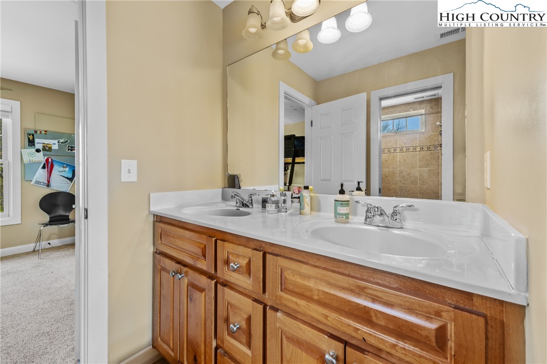 162 Pinecrest Court Boone, NC 28607 - Photo 37 of 50 a bathroom with double vanity sink a mirror and vanity