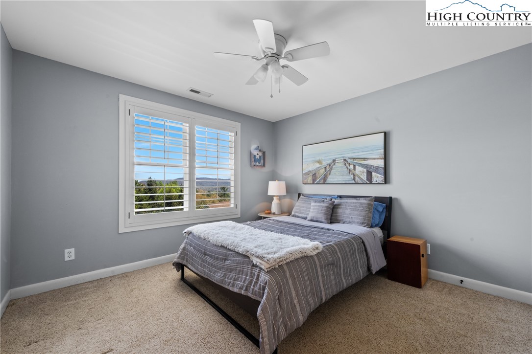 162 Pinecrest Court Boone, NC 28607 - Photo 41 of 50 a bedroom with a bed and a chandelier