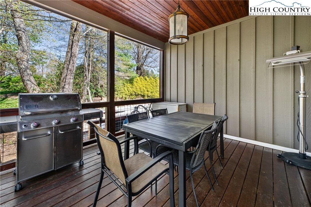 162 Pinecrest Court Boone, NC 28607 - Photo 44 of 50 a view of a patio with table and chairs with wooden floor and fence