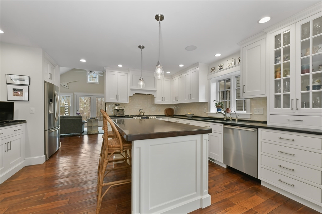 19 Smith Road Hingham, MA 02043 - Photo 3 of 18 a kitchen with stainless steel appliances granite countertop a sink a stove and a wooden floors
