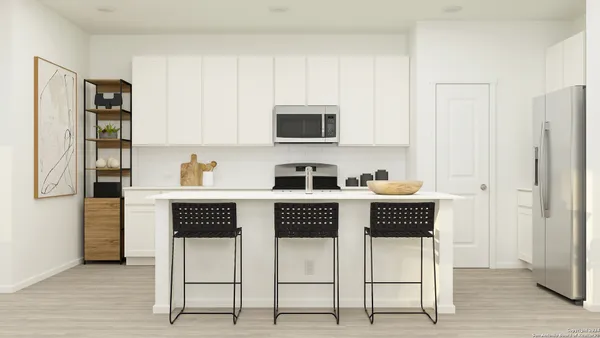 a kitchen with stainless steel appliances a stove a microwave and cabinets