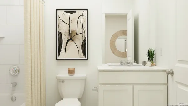 a bathroom with a sink vanity mirror and toilet